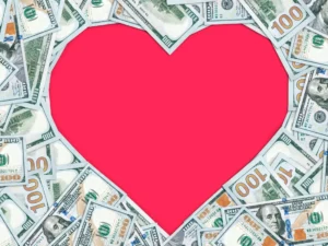 A large red heart shape, beautifully outlined with various denominations of U.S. dollar bills, showcases a unique financial love language.
